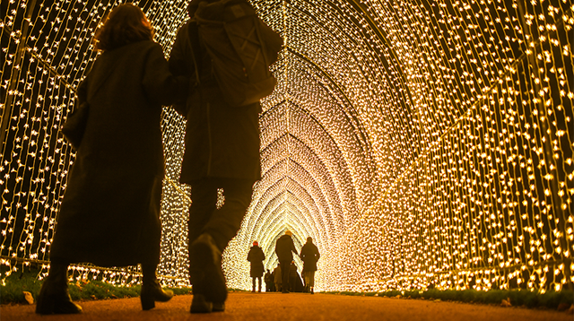 People are seen walking through a tunnel of lights at the Royal Botanic Gardens Edinburgh